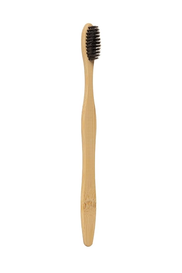 Bamboo toothbrush in bathroom setting on ceramic tray