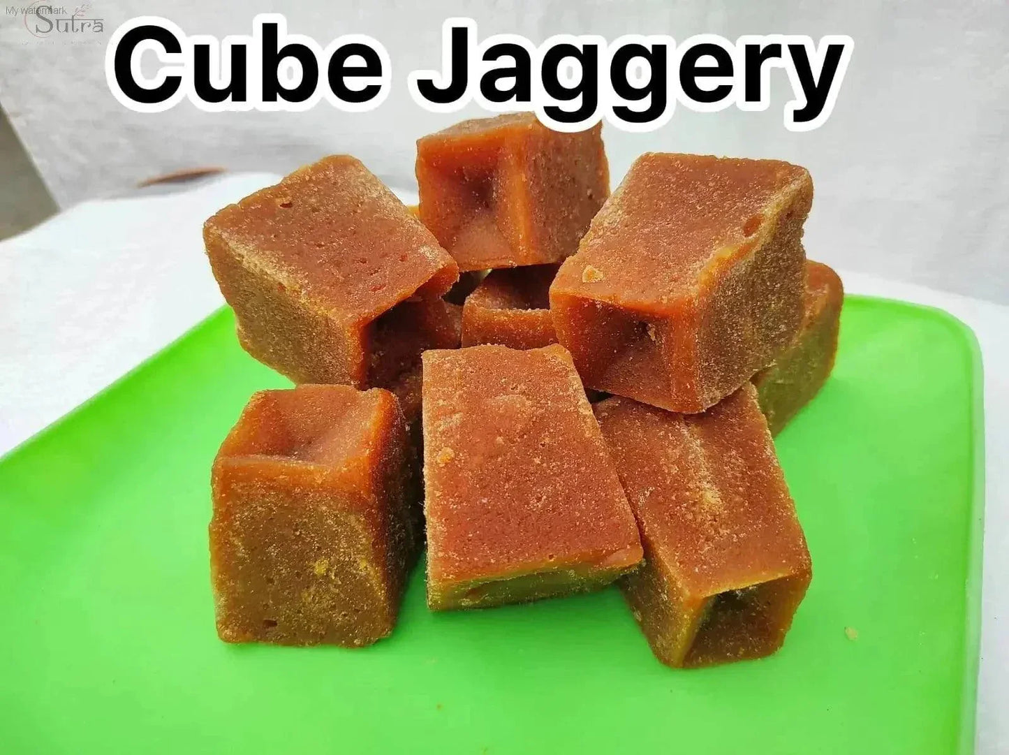Delicious Natural Jaggery Powder cubes on a green tray natural sweetener for healthy living.