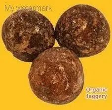 Delicious Natural Jaggery Powder balls on a yellow background, natural sweetener for healthy living.