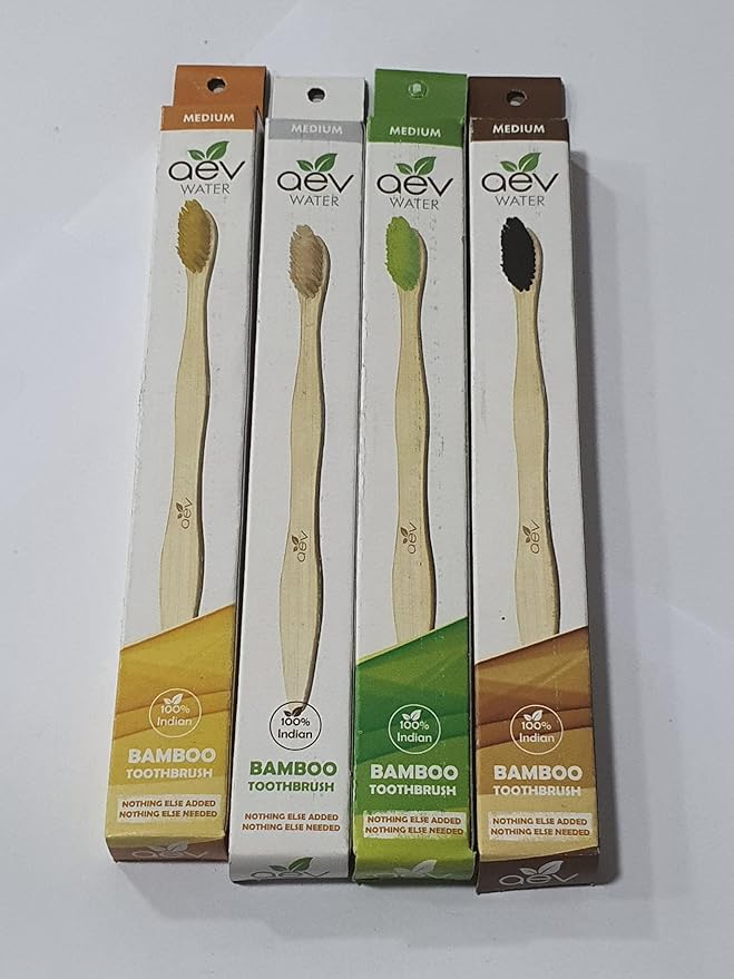 Hand holding AEV Water Bamboo Toothbrush under running tap