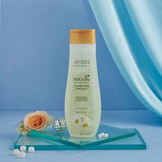 Jovees Shampoos bottle with herbal ingredients for hair care.