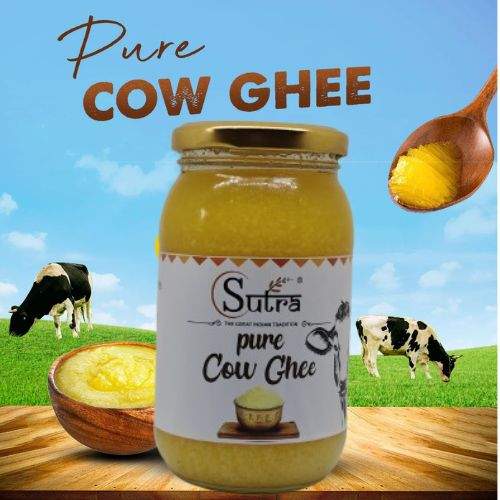 Pure Cow Ghee jar with grass-fed cows in the background, highlighting its natural and healthy quality for cooking.
