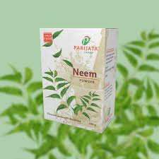 Parijata Herbs Neem Powder packaging on leafy background.