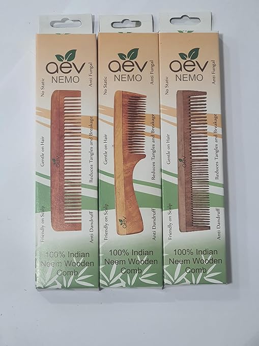 Comb on Wooden Surface with Oil Bottle