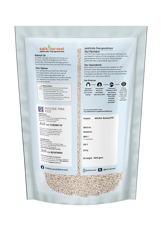 Raw white sesame seeds on wooden spoon